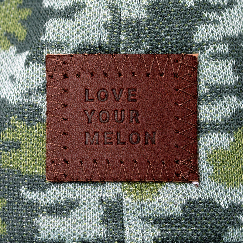 Close-up of patch on a green camo cap